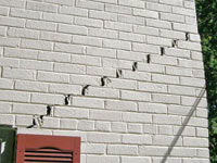 Stair-step cracks showing in a home foundation in Florence