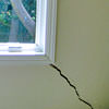 A long, diagonal crack that begins at a window corner of a Aiken home