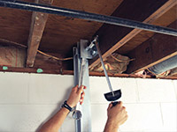 Straightening a foundation wall with the PowerBrace™ i-beam system in a Spartanburg home.