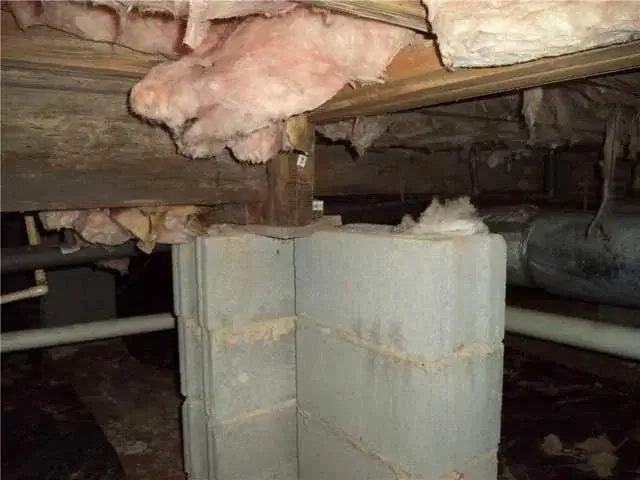 Here's a look at the crawl space with the insulation falling from the ceiling. This is typical of old, fiberglass batt insulation.