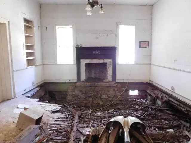 Removal of rotted wooden floor in one of the rooms.