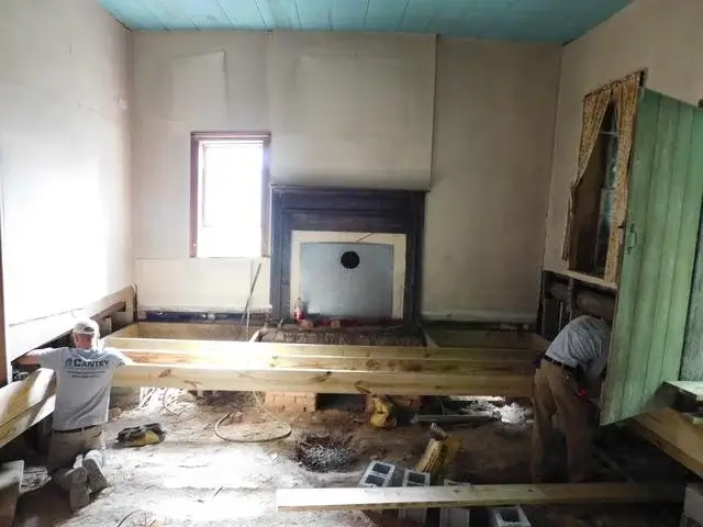The production crew then begins removing rotted wood beams and replacing the joists. New beams and cross beams are then installed.
