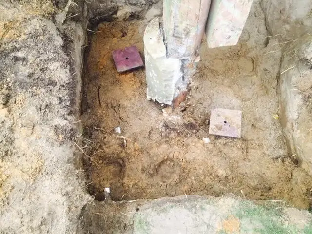 The original piers were broken off and eroded, and Cantey drove two helical piers to stabilize it.