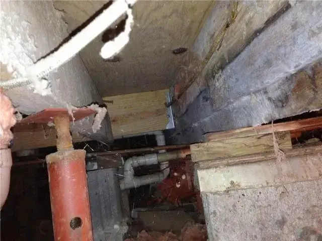 The jacks that were put in place to give extra support were not strong enough to hold the weight of the home, causing the sloping floor.