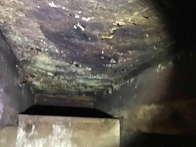 Crawl space view of rotted sub floor.